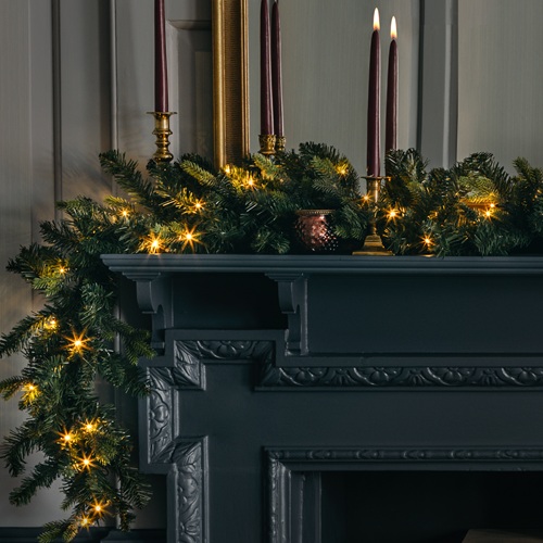 Image of 9ft pre-lit fake fir garland with warm white battery-powered lights.